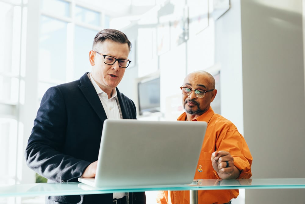 two-men-discussing-laptop